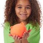 girl holding an orange giant kitty neato ball
