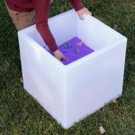 purple sand in a light up sensory table cube