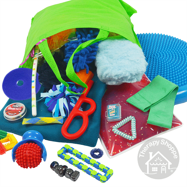 green tote bag with fidgets and chewy tools spilling out of it. There is also a fleece lap pad, a gel pad, and a wiggle cushion.